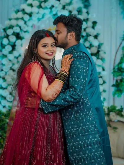 After the ceremonies, the reception is a time to celebrate as a newly married couple. A tender kiss on the forehead is a perfect, unscripted moment that I look for, capturing the love and connection between the partners.