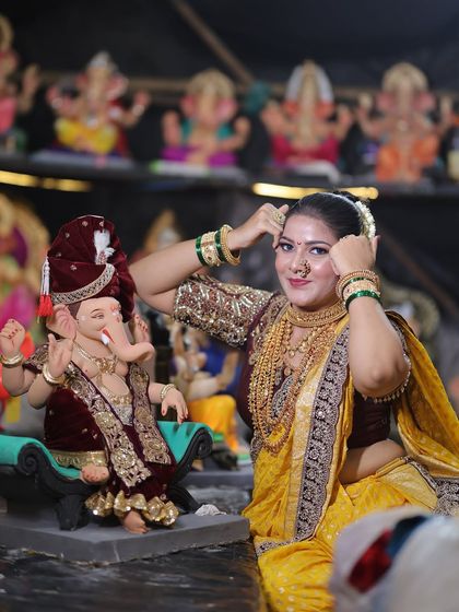 The full festive look, complete with green bangles and a warm, happy smile.