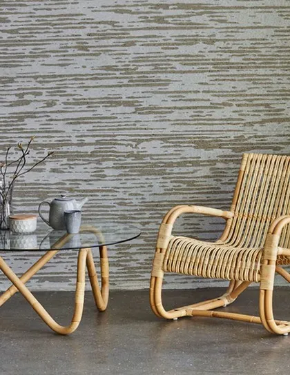 Here is a classic rattan lounge chair paired with a matching coffee table that has a durable glass top. This design highlights the gentle curves and expert binding I use to create comfortable and timeless pieces for any living space.