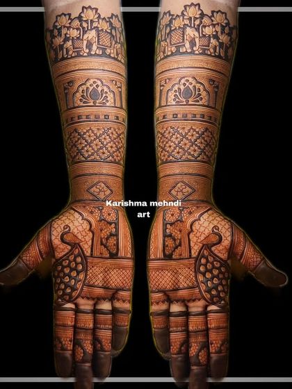 A symmetrical bridal design featuring peacocks on the palms and a procession of elephants at the top of the arms. The use of negative space makes the traditional motifs stand out beautifully.