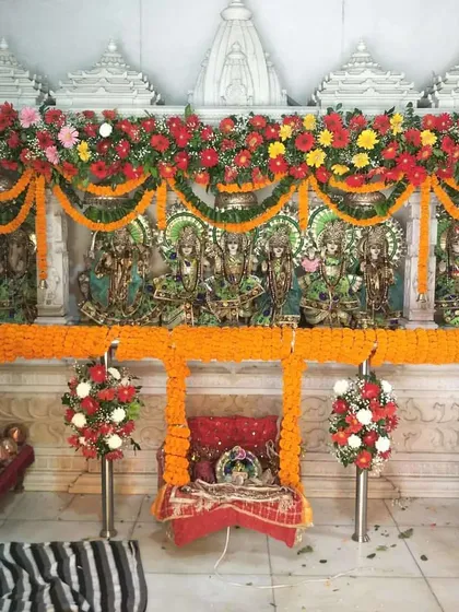 Another view of the Janmashtami temple decoration, showing the beautiful garlands and the floral jhula, creating a vibrant and devotional atmosphere for worshippers.