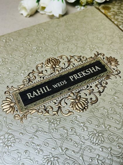 A beautiful embossed card with a floral brocade pattern. The gold-on-cream design is a classic choice for timeless elegance.