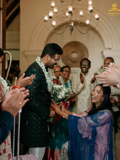 Our planning process is all about creating moments of pure joy for you and your family. Here, the groom is welcomed with laughter and applause at the Mehendi ceremony.
