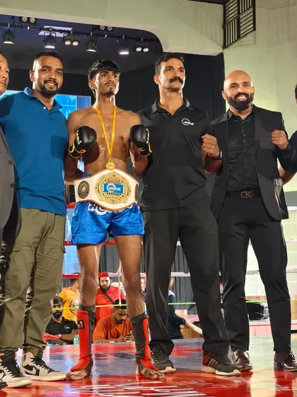 Surrounded by officials and team members, celebrating a huge title belt victory.