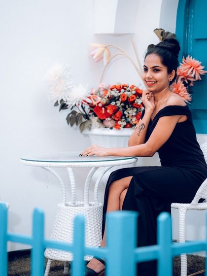 A stylish portrait of a woman at a cafe-style setting, perfect for a pre-wedding or solo portrait session.