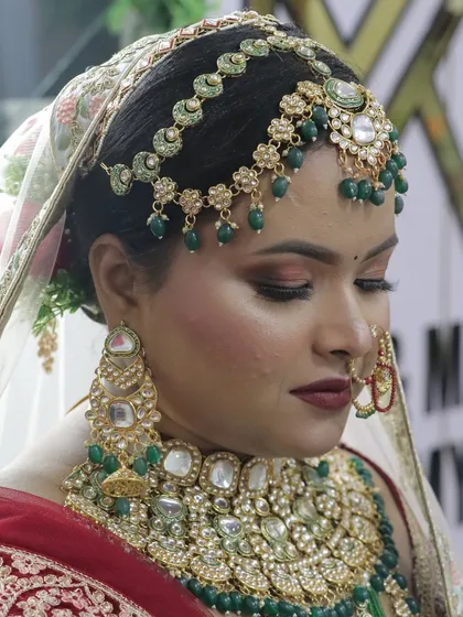 A side profile with eyes closed, showcasing the expertly blended eyeshadow and the flawless base makeup.