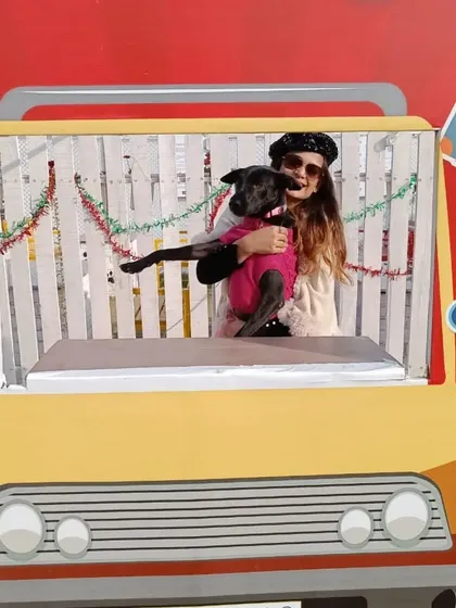 A guest and her dog strike a pose in the Christmas Carnival photo booth. Themed props and backdrops are a must for any festive event I plan.