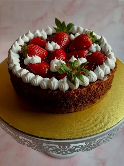 A beautiful cake from our Strawberry Season Specials menu. This cake is loaded with fresh strawberries and a sweet strawberry glaze, surrounded by delicate whipped cream piping.