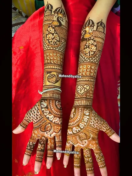 A beautiful bridal design with peacocks, lotuses, and the couple's initials. The mix of different elements creates a unique and personalized look.
