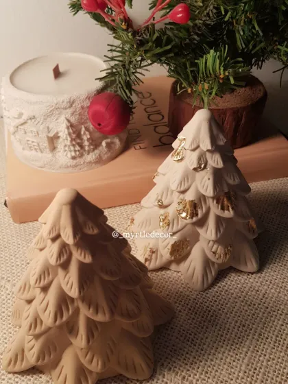 Our decorative Jesmonite Christmas trees, designed to add a touch of simple, handcrafted elegance to your holiday setup. One is left in its natural stone finish, while the other is detailed with gold leaf for a little extra sparkle.