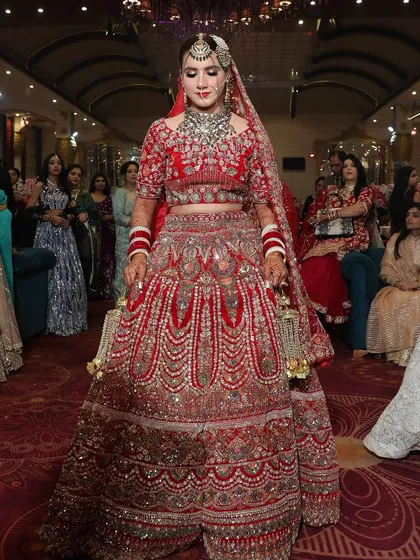 This bride's entrance was breathtaking. Her makeup was designed to be glamorous and eye catching, perfect for a grand wedding celebration.