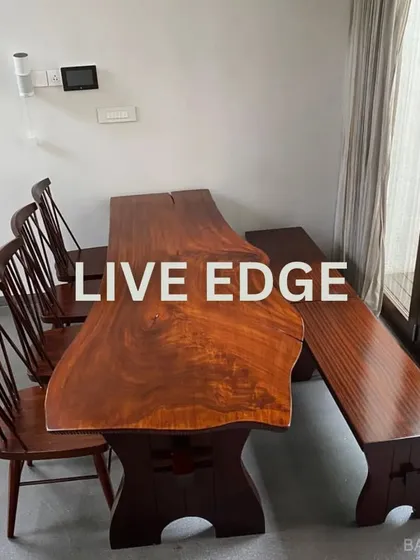 We love incorporating natural textures into our designs. This live-edge wooden dining table brings organic warmth and character to the dining space, proving that furniture can be both a functional piece and a work of art.
