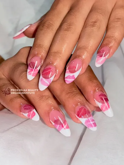 A fun and flirty design with hand-painted pink lips on a white and pink patterned base. This look on almond-shaped nails is playful and full of personality.