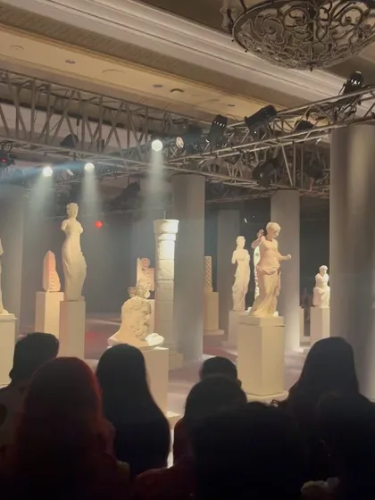 The dramatic staging and lighting at the couture show. The entire production is a creative work that requires legal protection, from set design to music rights.