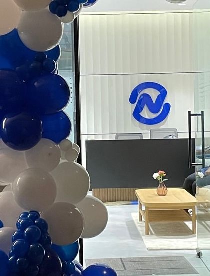 The balloon arch at the office entrance, perfectly framing the company's logo at the reception desk and creating a welcoming and celebratory first impression for employees and visitors.