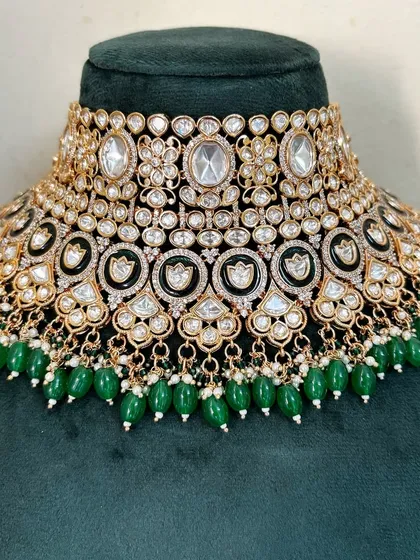 An elaborate bridal choker with multiple layers of Kundan stones and green bead drops. This rental piece offers a very grand and full look.