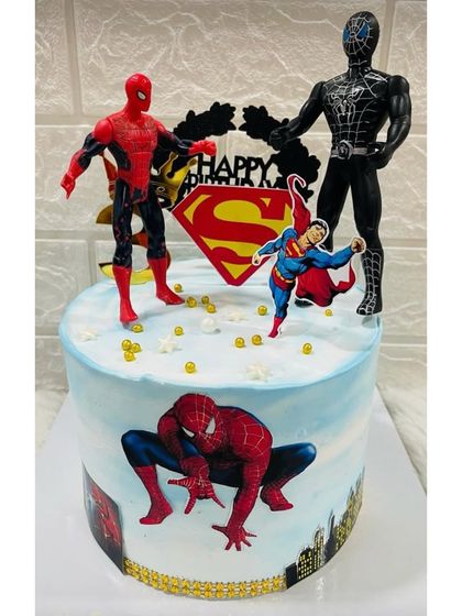 A superhero showdown cake featuring Spider-Man and Superman. This design includes action figures and printed cityscapes for a dynamic and exciting birthday centerpiece.