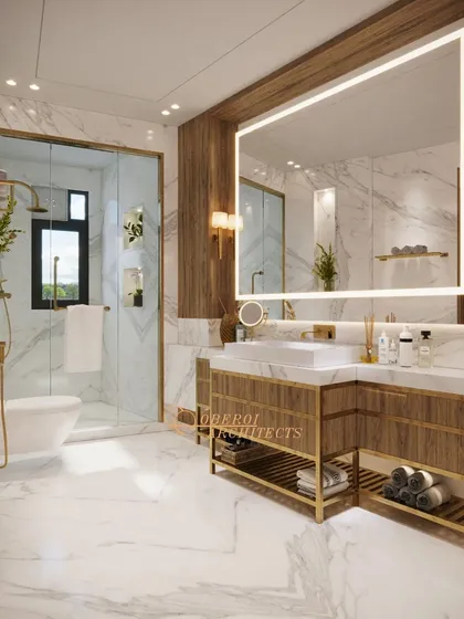 A luxurious bathroom featuring a mix of white marble and wood panels, a large backlit mirror, and gold-finish fixtures for a warm, opulent feel.