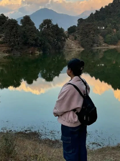 A moment of quiet reflection by the serene Deoria Tal. Some journeys are more beautiful than the destination itself.