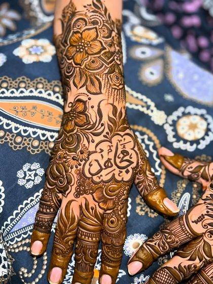 A beautiful design featuring a name in Arabic calligraphy, surrounded by intricate floral and leaf patterns. I can write any name or word you wish.