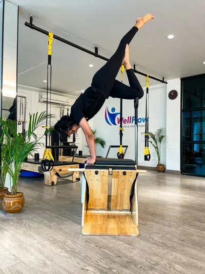 This is what strength, balance, and control look like. A client demonstrates an advanced posture on the Wunda Chair, showcasing the incredible physical capabilities that can be unlocked through consistent, mindful Pilates practice at our studio.