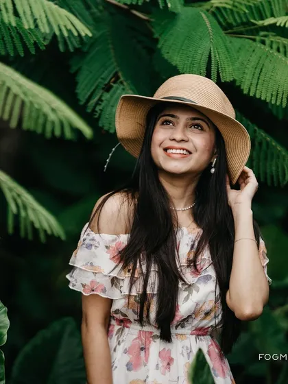 A lovely solo portrait taken during a pre-wedding session. The soft, natural light and the garden background create a dreamy and romantic mood.