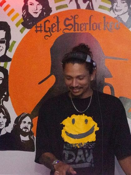 A close-up of DJ Kevin at the console. He's focused on delivering the perfect mix to keep the party going all night long.