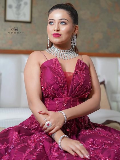 A glamorous portrait of the bride in her stunning engagement gown, showcasing her elegant style and diamond jewelry.