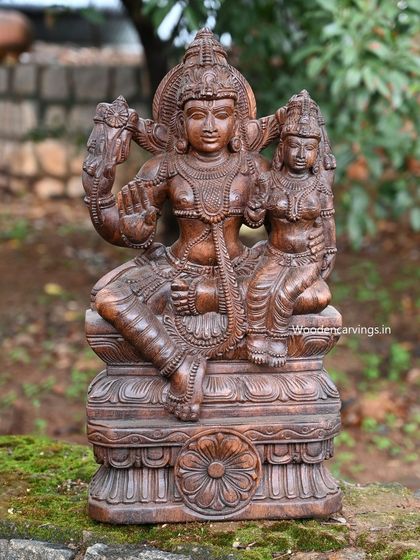 A slightly different angle of the Vishnu and Lakshmi sculpture, highlighting the fine details of their forms.
