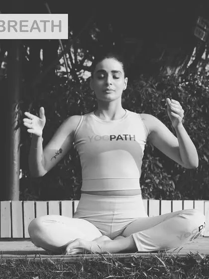 A practitioner demonstrates Bhramari Pranayama, also known as the Humming Bee Breath. This technique is incredibly effective for instantly calming the mind, relieving tension, and reducing feelings of anxiety.