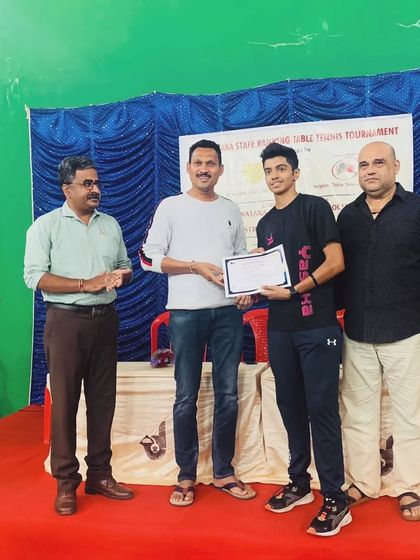 Aakash KJ receiving his certificate for being the U19 Runner-up at the Belagavi district State Ranking Tournament.