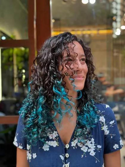 A happy client enjoying her new pop of color. The turquoise ends add a playful and edgy vibe to her look.