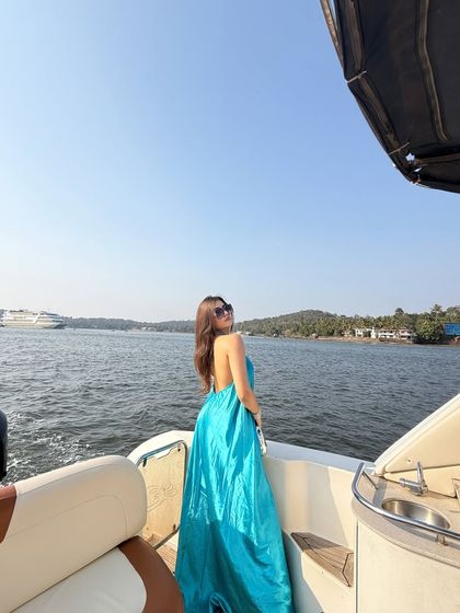 A back shot, showing the open-back design of the dress and the beautiful scenery.