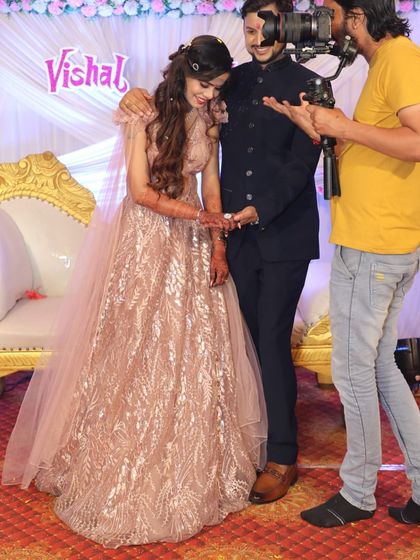 A behind-the-scenes look at an engagement ring exchange. The bride-to-be looks radiant in her sparkling golden gown.