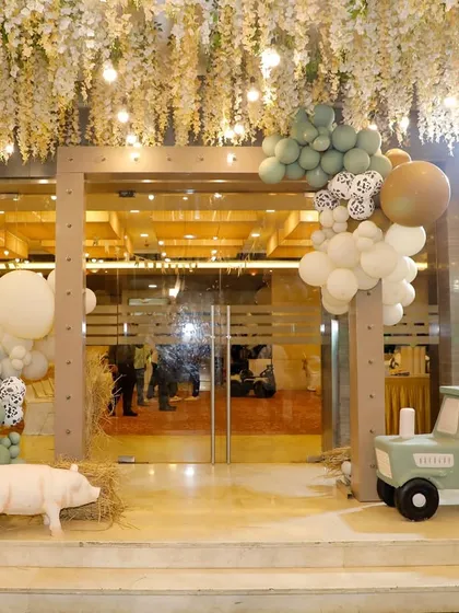 The entrance to Vyom's farm party, where a custom tractor prop and directional signs pointed guests toward the fun.