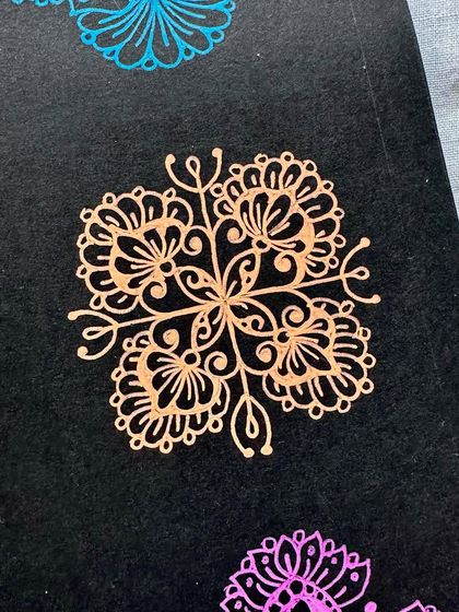 A bronze-colored mini mandala, showing the beautiful metallic sheen that some Gelly Roll pens have.