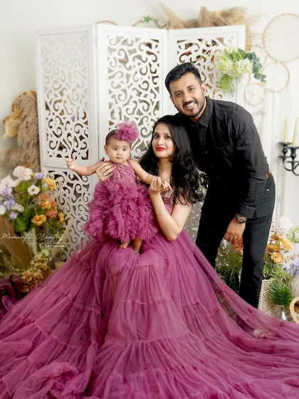 Another beautiful pose from this elegant family session. The mother holds her daughter, both in matching gowns, creating a picture of grace and love.