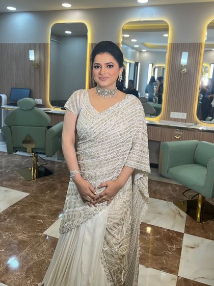 The full look, featuring a stunning white saree and a classic, elegant makeup style. Perfect for any formal occasion.