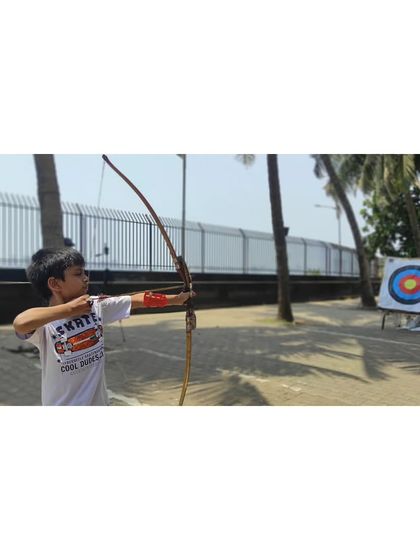 This young boy shows great potential with his steady aim and good posture.