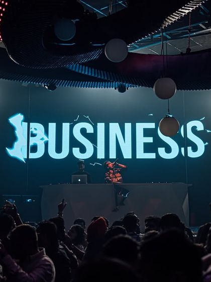 The 'Business' visual on screen at Prism Mohali, setting the tone for the night.