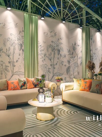 The lounge area of 'The Conservatory' at night, with the custom wallpaper beautifully illuminated.
