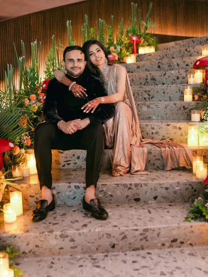 A portrait of the happy couple, seated amidst the unique, candlelit decor of their Citrus Safari reception.