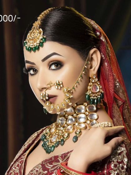 A heavy Polki bridal set with large uncut stones and green accents, available for purchase. A true investment piece for your trousseau.