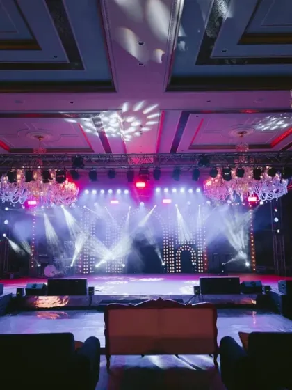The empty stage before the Sangeet begins, showcasing the complex lighting rig and LED screen setup. This highlights the professional production quality I bring to every event.