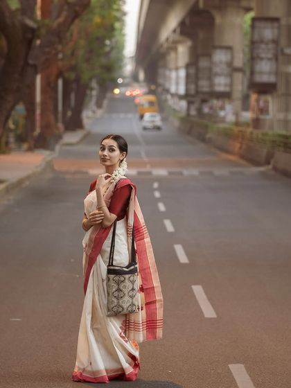 A full-length shot from the urban series, showing the complete look with the saree and bag.