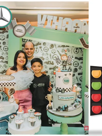 The happy family poses with the incredible F1-themed cake. These are the cherished moments that make all the detailed planning worthwhile.