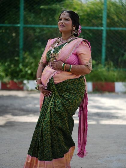 A full-length shot showcasing the elegant saree drape and the overall grace of the mom-to-be.