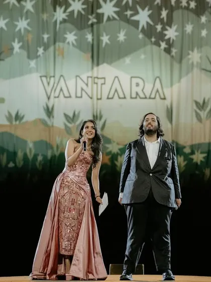 Radhika and Anant on stage during their 'Everland' themed pre-wedding event, as featured in Vogue Magazine. This photo captures the scale and theatricality of the celebration they created for their loved ones.