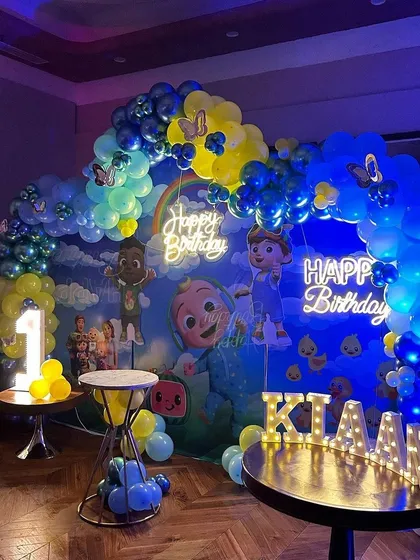The full Cocomelon party scene for Kiaan, showing how all the elements, including the light-up name, come together to create an impressive and festive environment.