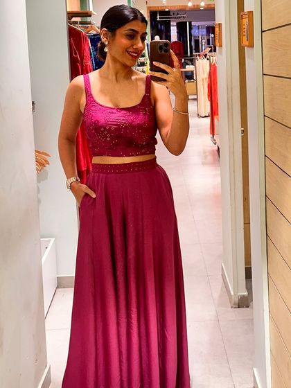 A mirror selfie in a vibrant magenta co-ord set, a perfect example of a modern festive outfit.